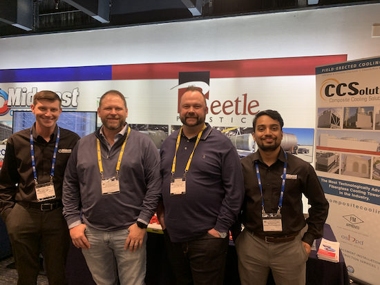 Four men stand together at a trade show booth in front of signage for Midwest, Beetle Plastics, and CCSolutions composite cooling towers.